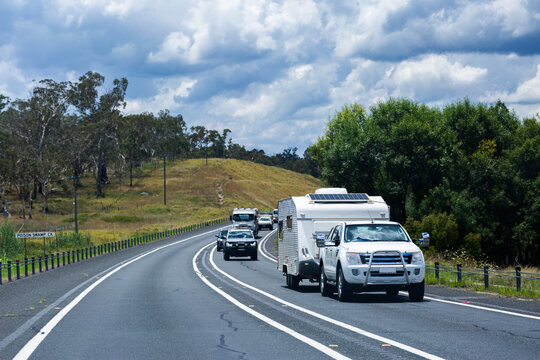 Car pulling caravan traveling along highway road going on holiday trip through Australia