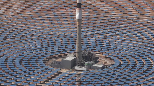 Aerial view of Torresol Energy Gemasolar solar power plant with concentric heliostat mirrors and central receiver tower in Fuentes de Andalucia, Andalucia, Spain.