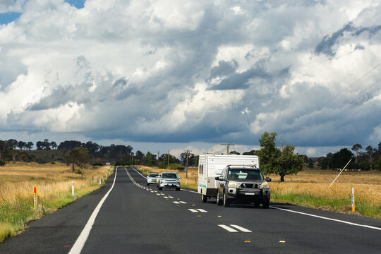 Car pulling caravan traveling along highway road going on holiday trip through Australia