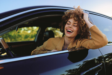 Fototapeta premium Cheerful woman inside a car, laughing with head tilted back, sunlit moment, casual chic style, retro film color vibe, candid lifestyle shot, warm tones, vibrant outdoors scene in natural light