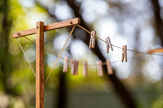 Old fashioned string clothes line with wooden pegs