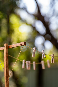 Old fashioned string clothes line with wooden pegs