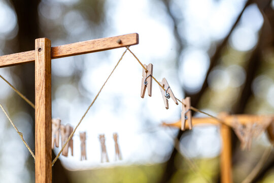 Old fashioned string clothes line with wooden pegs