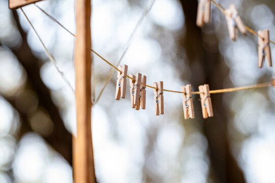Old fashioned string clothes line with wooden pegs