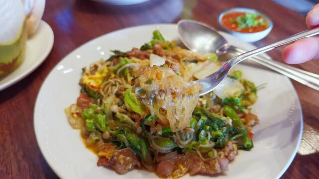 Close-up of Stir-fried Glass Noodles (Suki) with Vegetables and Meat - Handheld Food Action Shot