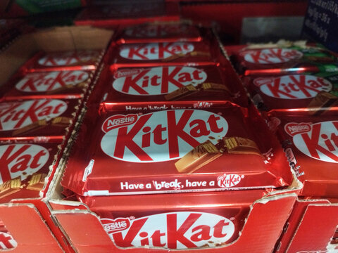 Nestle KitKat chocolate bars stacked on a store shelf in bright red packaging. Famous candy brand, wafers, glossy wrappers, and retail display. Karagandy, Kazakhstan - May 14, 2026