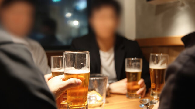 Group of close friends clinking beer glasses together at a wooden table inside a cozy pub or bar at night, gathering for a casual corporate happy hour after work, socializing and celebrating