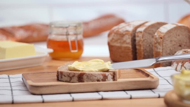 Butter spreading on fresh bread slice, close up homemade breakfast scene, copy space