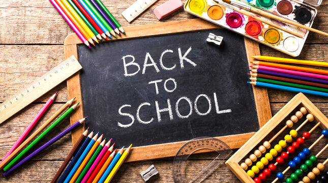 Back to school sign with art supplies on wooden table, education system