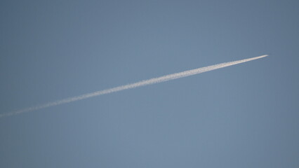 Commercial airplane flying high in a clear blue sky © Viktor