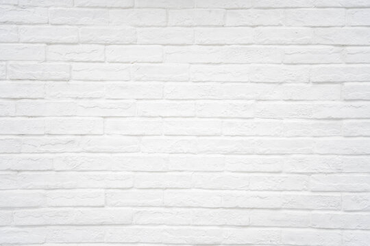 Old grunge white painted brick wall texture background. Loft-style wall