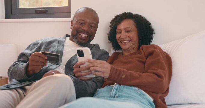 Relax, sofa and couple with phone and credit card for online shopping or dream purchase in home. Excited, African man and woman with bank transaction, loan or e commerce app for apartment furniture