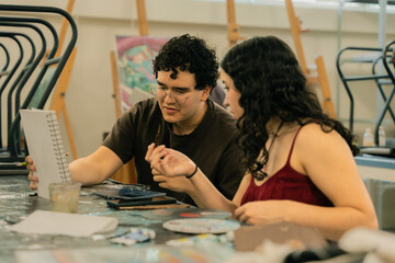 Fototapeta premium Young artists collaborating on a drawing project in art studio