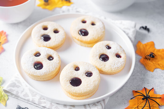 Linzer cookies in the form of scary monster for Halloween holidays in a plate