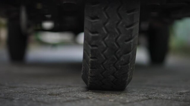 Close-Up of Three-Wheeled Garbage Motorcycle Tire Stopping