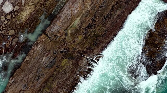 Surf of Southern ocean waves eroding rocky coast of Victoria Great Ocean road edge.