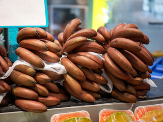 Stack of Red Bananas at Market Stall © Dong