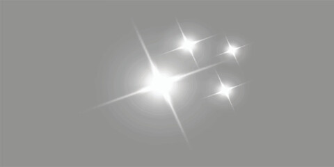 Four bright starburst light effects with lens flares on gray background light effect lens flare star shine sparkle shine glow starburst abstract © Muhammad