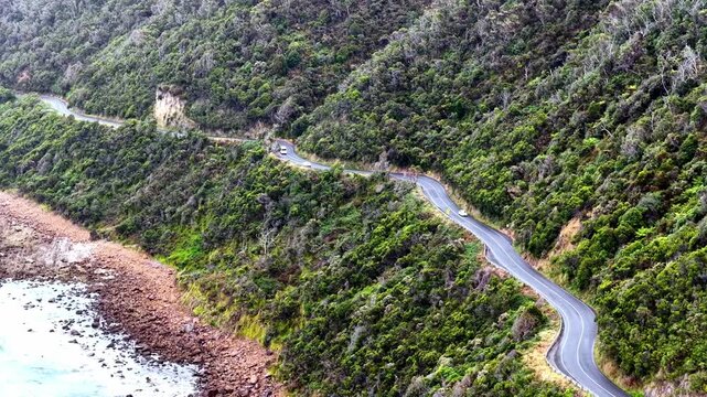 Great Ocean road B100 highway cliffy waterfront rocks traffic aerial landscape in Australia.