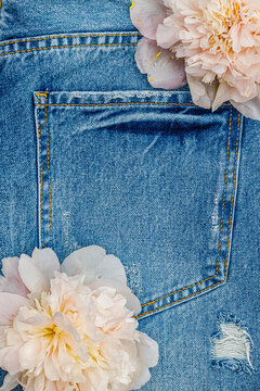Flowers placed on denim fabric with a pocket in view during daylight