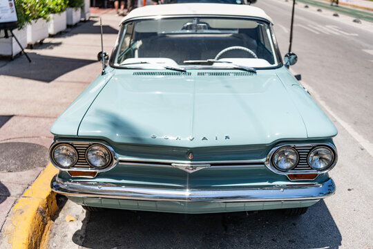 Miami, Florida, USA - May 06, 2025: Chevrolet Corvair 1964 convertible classic car. Luxury convertible car Chevrolet Corvair. Car Chevrolet Corvair parked outdoor. Blue Chevy retro car, front view.