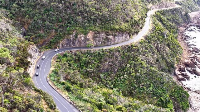 Passenger cars driving on Great Ocean road scenic B100 highway in Victoria &ndash; aerial view.