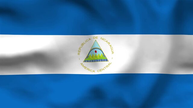National flag of Nicaragua on wavy cloth. Features blue and white horizontal bands with the triangular emblem. Top-down view for Central American news and national holidays.
