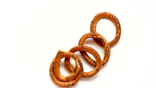 Crispy baked bagels with poppy seeds floating composition