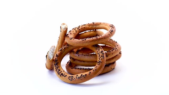 Crispy baked bagels with poppy seeds floating composition