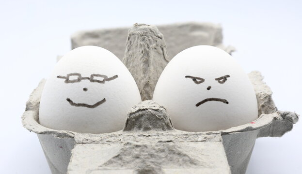 Egg photo. Concept of expesive egg prices. Happy and angry faces.