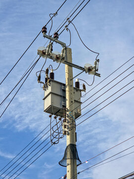Vertical View of Electrical Transformer on Utility Pole with Power Lines