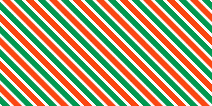Christmas seamless pattern. Red and green diagonal stripes background. Candy cane repeating decoration wallpaper. Winter holiday lines backdrop. Xmas peppermint present wrapping print design. Vector