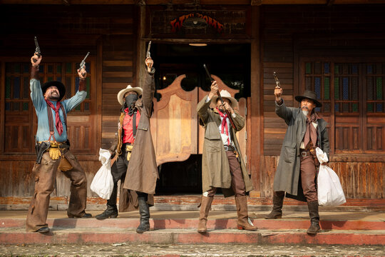 Epic western showdown cowboys duel in old town theatrical performance rustic setting audience perspective action-packed drama