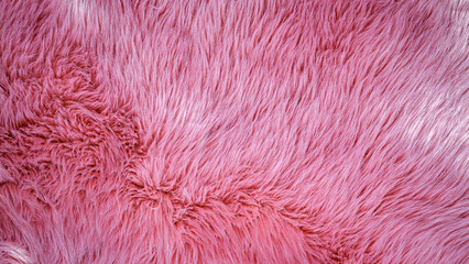 Fototapeta premium Soft pink furry texture close up showing the detailed strands and patterns of the fabric in daylight