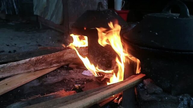 A traditional cooking method for snacks that uses a traditional molded frying pan and pieces of wood placed underneath to produce a large fire and smoky aroma in the resulting snack.