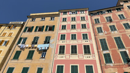 Colorful Traditional Italian Buildings with Green Shutters in Camogli Liguria © blueringmedia