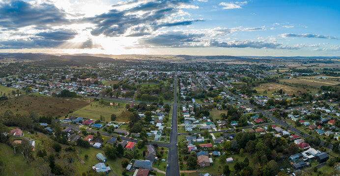 Sunrays through clouds in evening with view over town of Glen Innes in NSW Australia