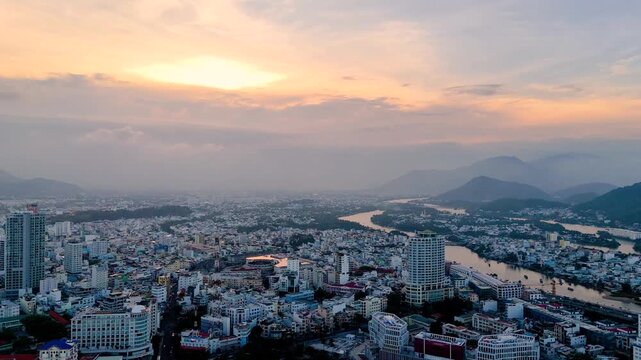 Central district and river with panoramic view of the city from a bird's eye view, evening on the coast of Southeast Asia, evening at sunset, sunset in Nha Trang