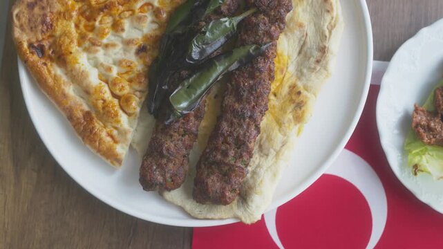 Close-up of Adana kebab menu on the Turkish flag