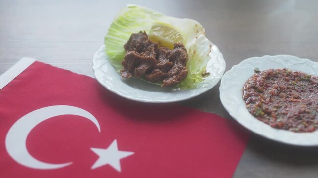 Close-up of traditional Turkish spicy bulgur balls Cig Kofte on Turkish flag