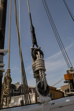 Wooden deadeye blocks with standing rigging on a traditional sailing vessel, vertical view