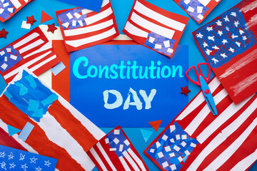 Fototapeta premium Constitution Day school project with handmade USA crafts, paper flags and decorations on blue background, creative classroom activity concept