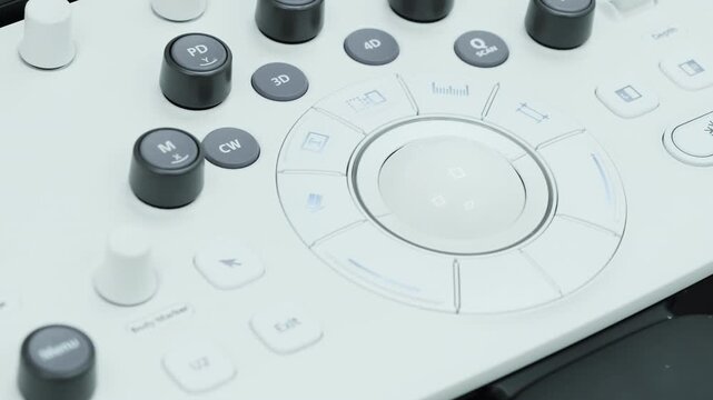 Diagnostic console displays control buttons and rotary keys for setup. Ultrasound system organizes functions supporting precise imaging control
