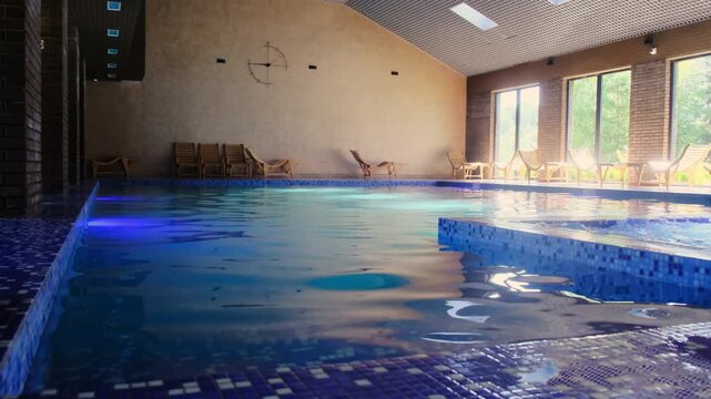Clear swimming pool with hydro massage tub at luxury spa resort. Enjoying activities and relaxation in water at hotel. Wellness procedures