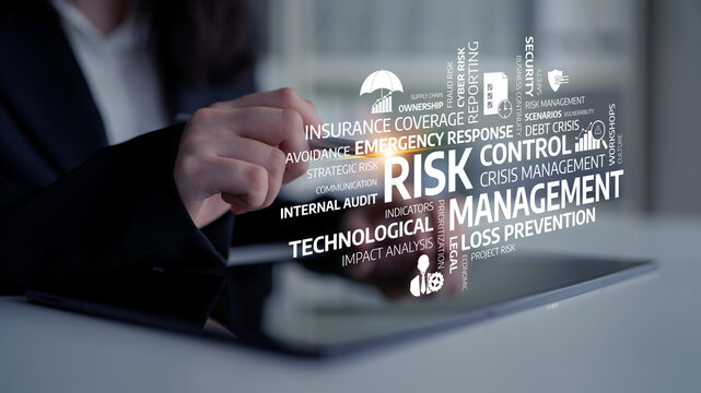 A business professional concentrates on risk management strategy while analyzing data on a digital tablet screen, highlighting control, crisis response, and prevention techniques. Tessel