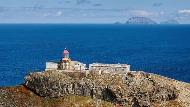 Farol Sao Lourenco lighthouse on rocky peninsula above Atlantic Ocean, Madeira Island, clear sky conditions