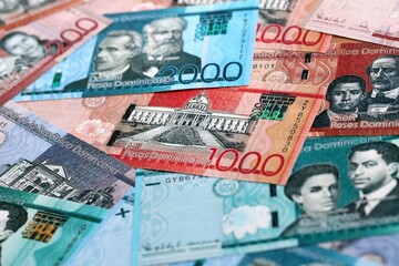 Fototapeta premium Dominican Republic peso money bills pile on table. Dominican Republic banknotes of DOP currency.
