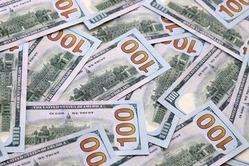 Obraz premium US dollar money bills pile on table. United States banknotes of USD currency close up.