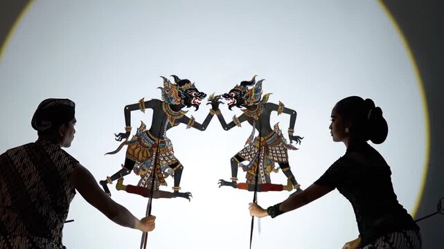 Man and woman perform traditional Javanese shadow puppet show