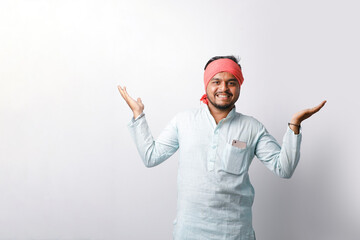 Fototapeta premium young indian farmer showing hand gesture standing on white background